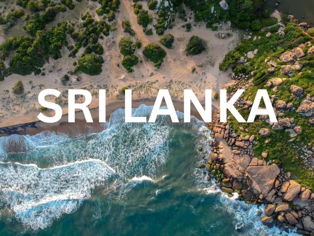 Aerial view of a Sri Lankan beach with waves crashing against rocks and green cliffs